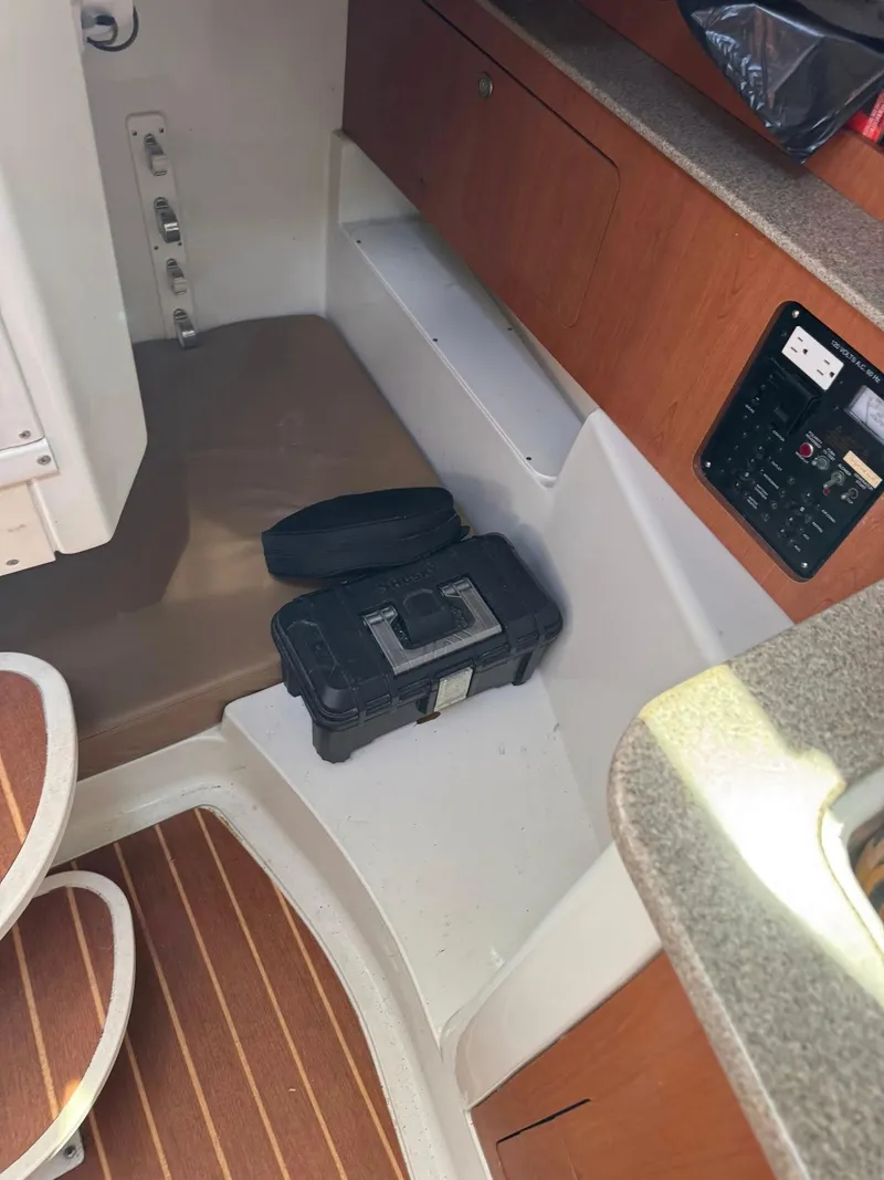 Slide: The Image of Interior of a 2008 Sailfish 30-06 Express boat with wooden flooring and storage compartments. - 7