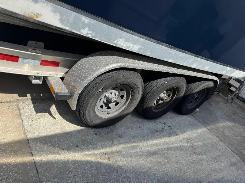 Slide: The Image of Triple-axle trailer for 2008 Sailfish 30-06 Express boat on concrete surface. - 9
