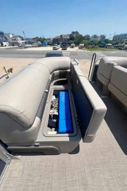 Slide: The Image of 2021 Sun Tracker Party Barge 20 DLX with open storage compartment on deck. - 13