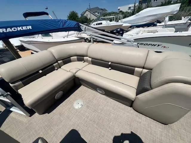 Slide: The Image of 2021 Sun Tracker Party Barge 20 DLX with beige seating, docked at marina. - 15