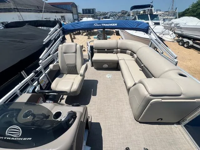Slide: The Image of 2021 Sun Tracker Party Barge 20 DLX with spacious seating and canopy, docked at marina. - 16