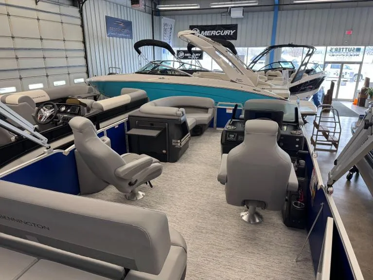 Slide: The Image of 2025 Bennington 22 MSB pontoon boat interior with modern seating in a showroom. - 3