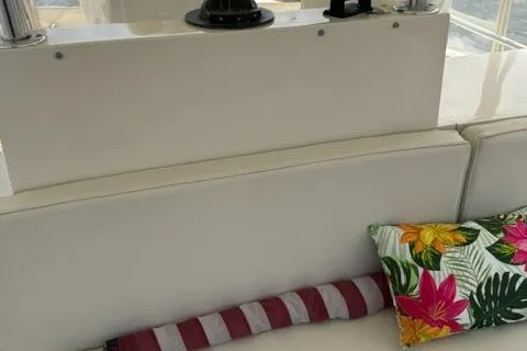 Slide: The Image of Interior of 1989 Viking 45 Convertible with striped and floral cushions on white seating. - 24