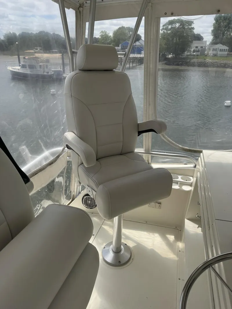 Slide: The Image of Captain's chair on 1989 Viking 45 Convertible yacht, overlooking serene waterfront. - 25