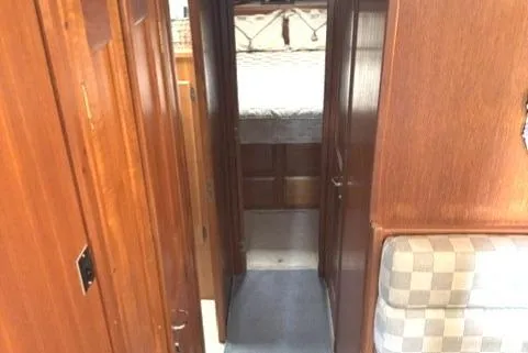 Slide: The Image of Interior hallway of 1989 Viking 45 Convertible yacht with wood paneling. - 7