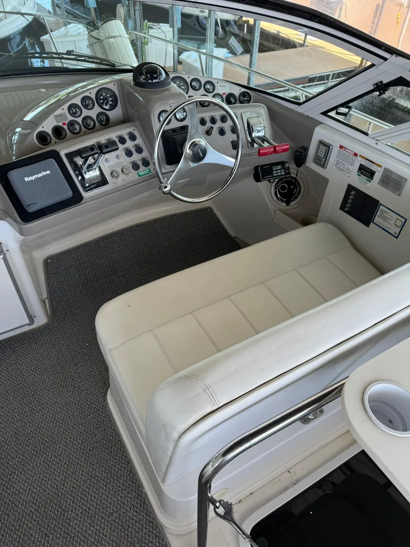 Slide: The Image of 2000 Carver 350 Mariner helm with steering wheel, controls, and navigation equipment. - 12