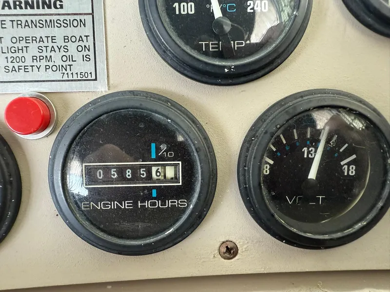 Slide: The Image of Dashboard gauges of a 2000 Carver 350 Mariner, showing engine hours and voltage. - 19