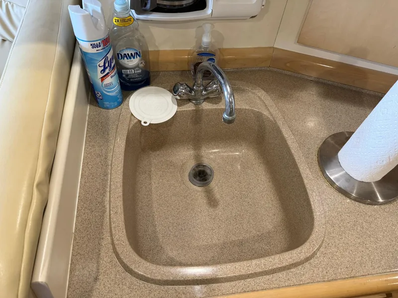 Slide: The Image of Sink area on a 2000 Carver 350 Mariner yacht with cleaning supplies. - 26