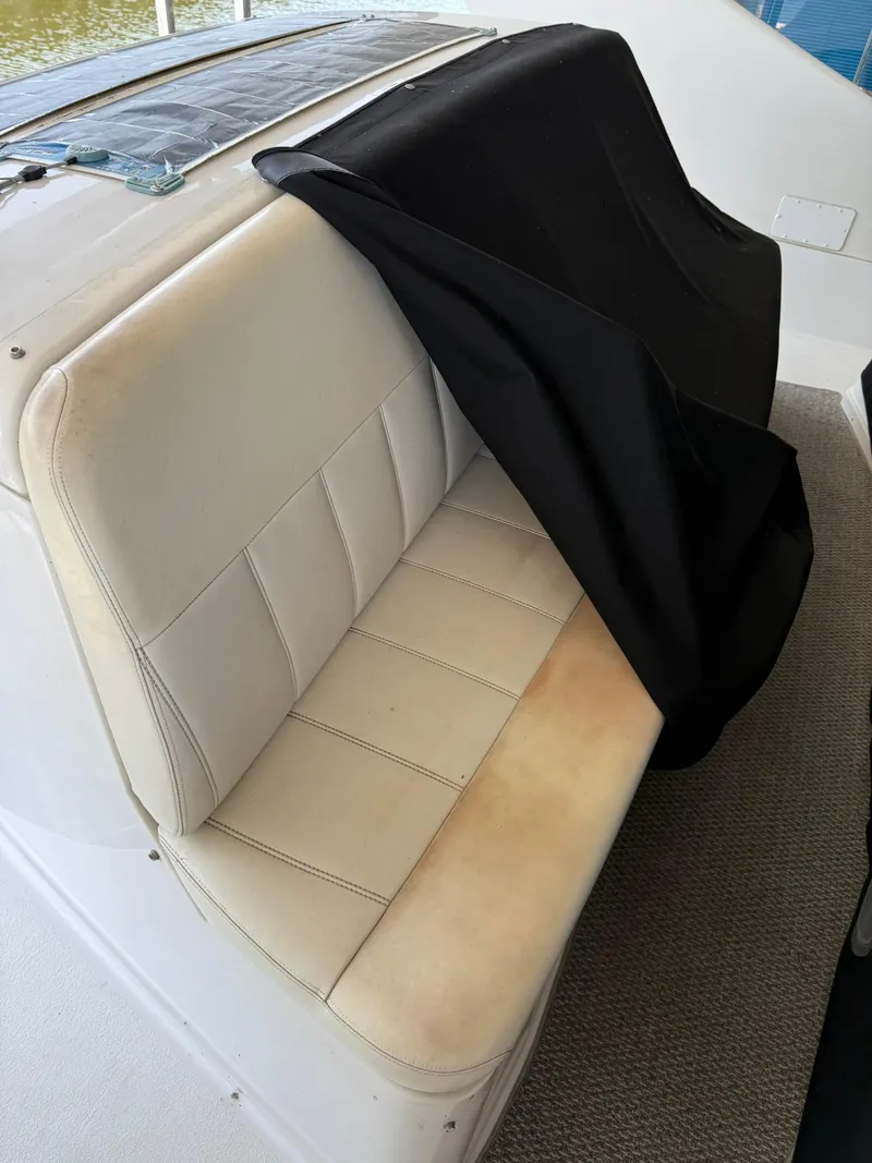 Slide: The Image of 2000 Carver 350 Mariner boat seat with black cover partially draped. - 7