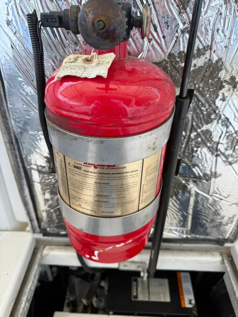 Slide: The Image of Red fire extinguisher in a 2000 Carver 350 Mariner engine compartment. - 37