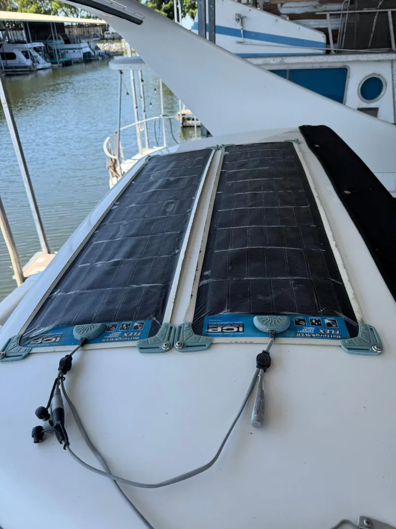 Slide: The Image of Solar panels on a 2000 Carver 350 Mariner boat docked at a marina. - 6