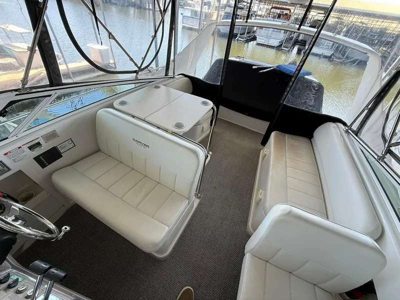 Slide: The Image of Interior of 2000 Carver 350 Mariner yacht with white seating and lake view. - 8