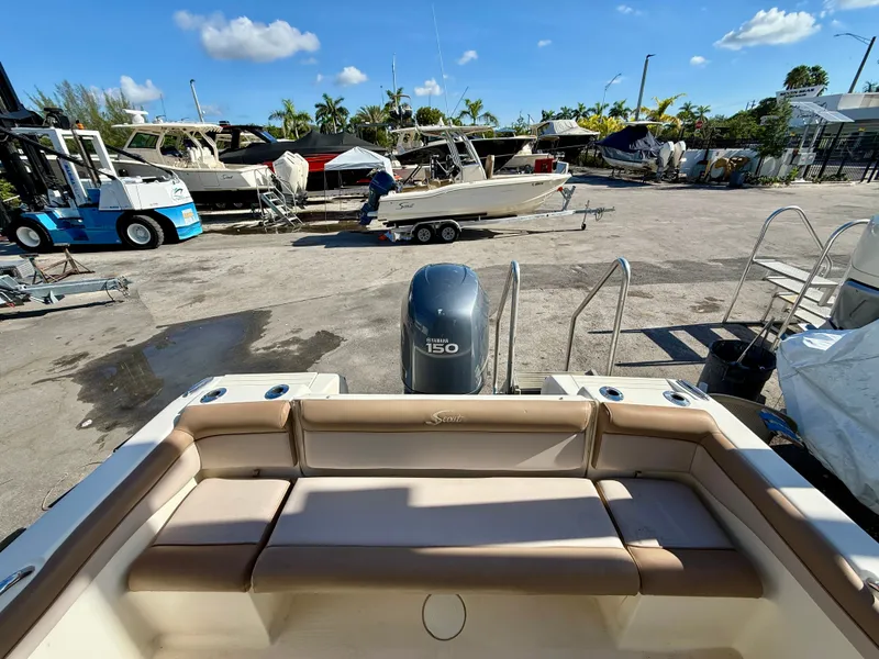 Slide: The Image of 2012 Scout 210 XSF boat with Yamaha 150 engine in a marina setting. - 3