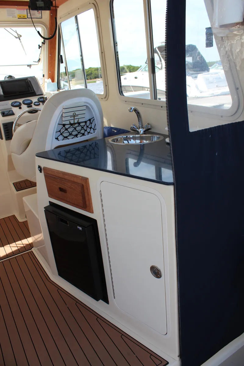 Slide: The Image of 2016 Eastern 27' Islander boat interior with sink, counter, and seating. - 11