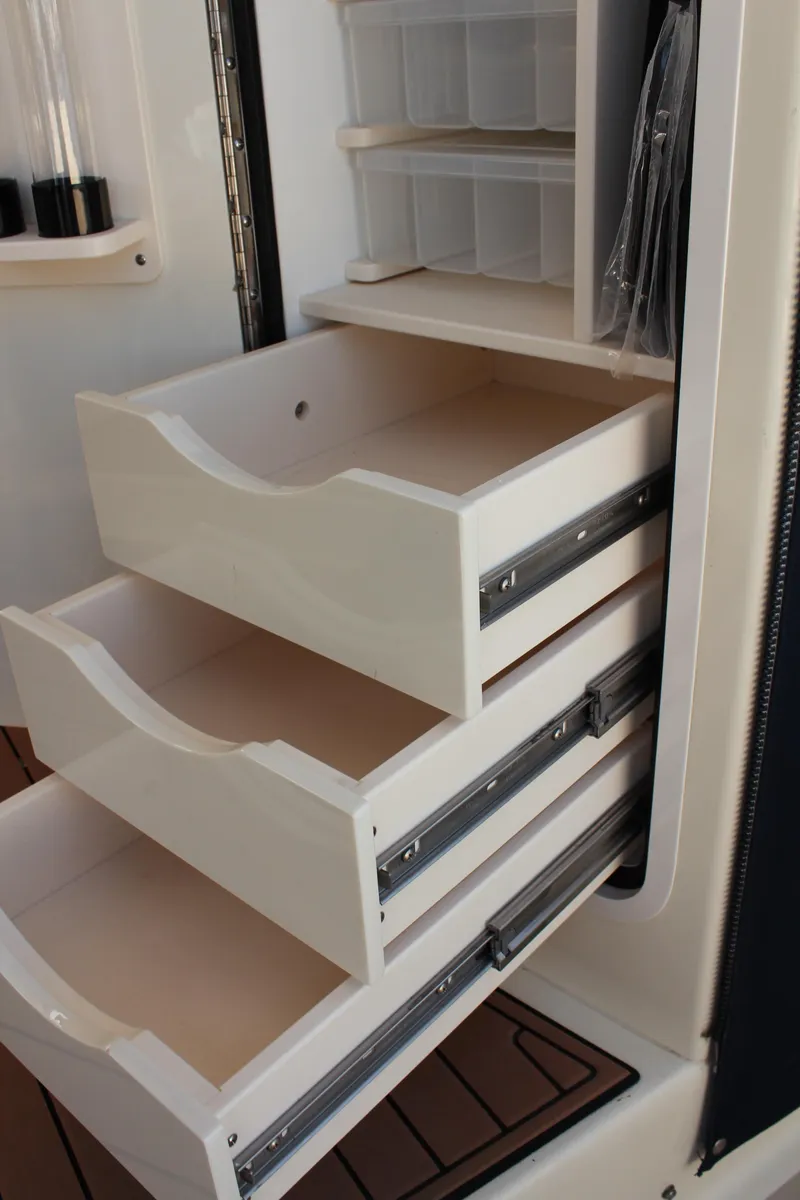 Slide: The Image of Cabinet drawers in a 2016 Eastern 27' Islander boat interior. - 12