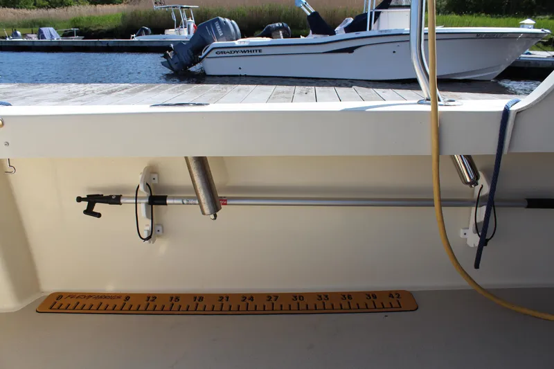 Slide: The Image of 2016 Eastern 27' Islander boat interior with fishing rod holder and measuring ruler. - 14