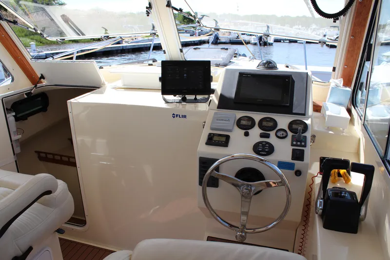 Slide: The Image of Interior view of 2016 Eastern 27' Islander boat cockpit with steering wheel and navigation equipment. - 16