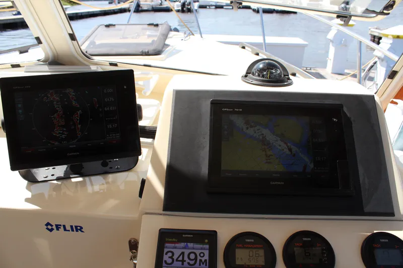Slide: The Image of Control panel of a 2016 Eastern 27' Islander boat with navigation screens and instruments. - 17