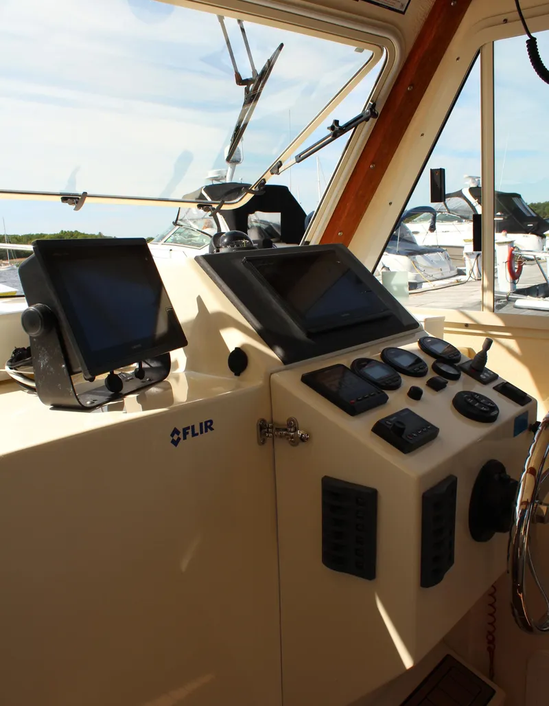 Slide: The Image of 2016 Eastern 27' Islander boat cockpit with navigation equipment and controls. - 19