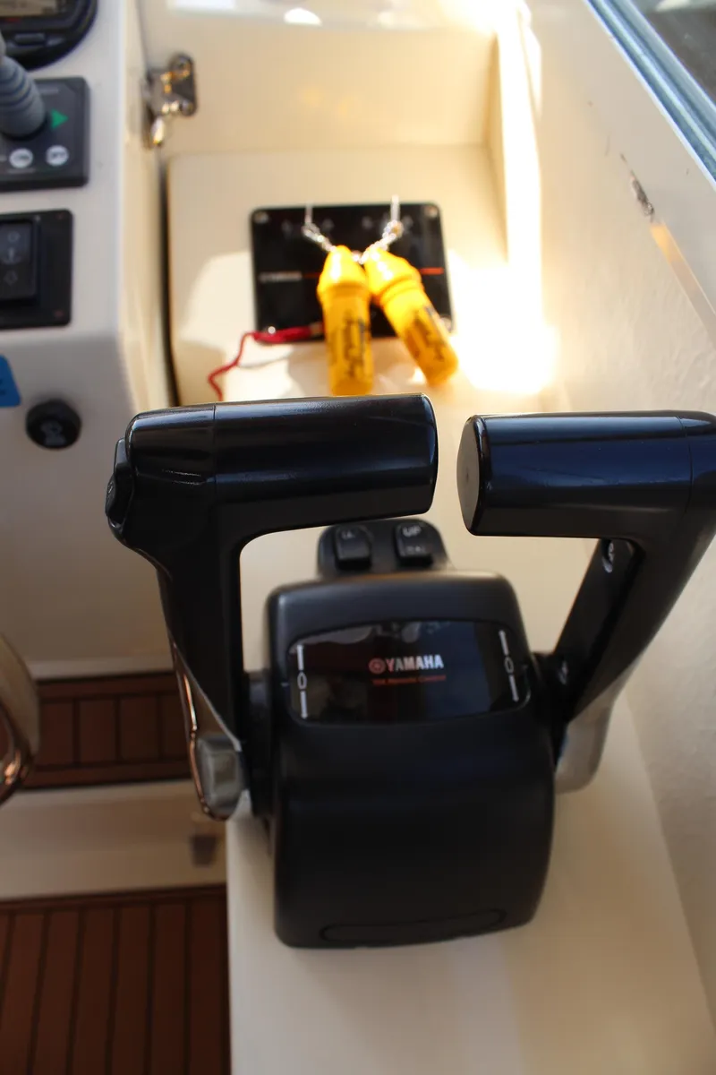Slide: The Image of Close-up of Yamaha throttle controls on a 2016 Eastern 27' Islander boat. - 22