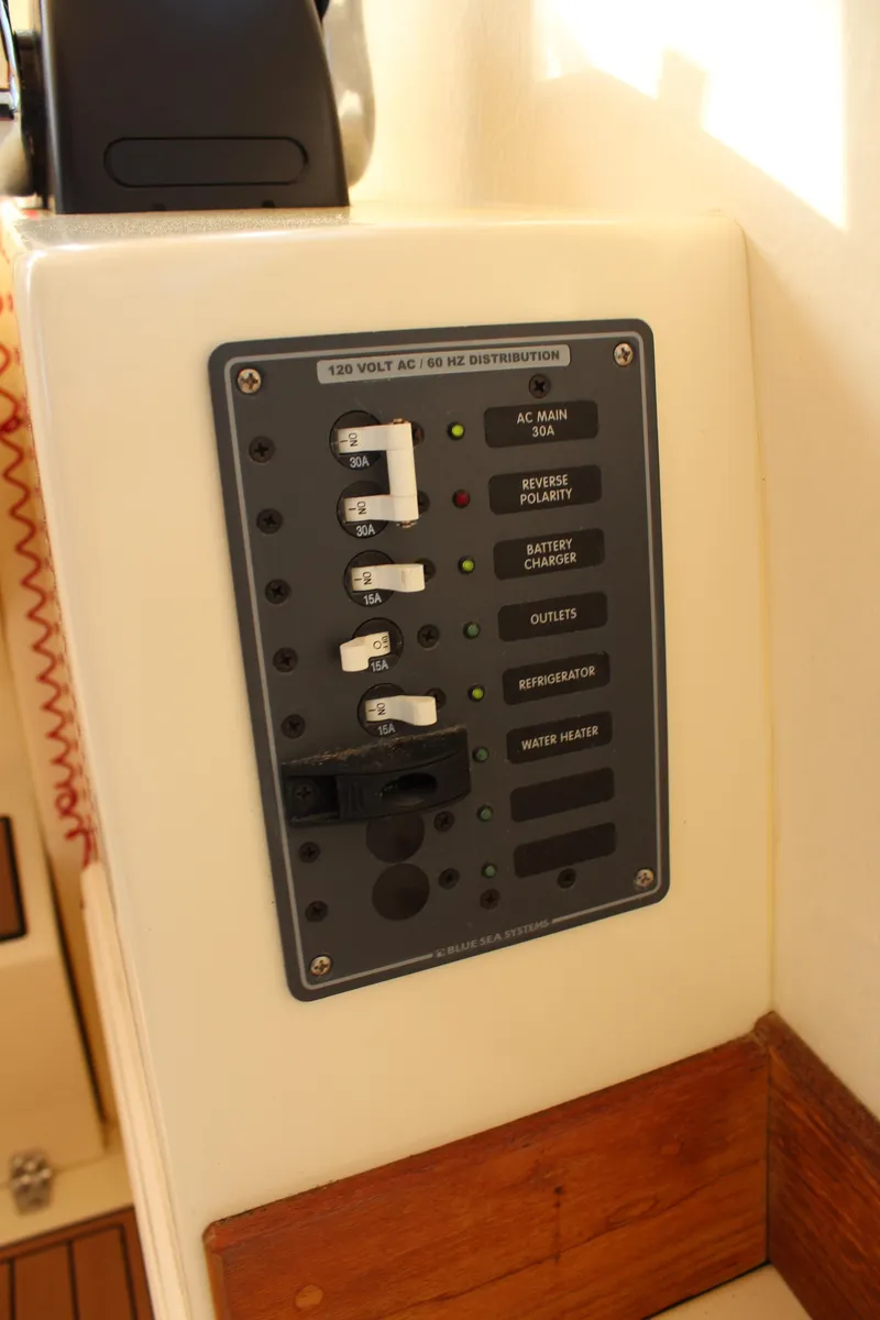 Slide: The Image of Electrical panel on 2016 Eastern 27' Islander boat, featuring labeled switches and controls. - 23