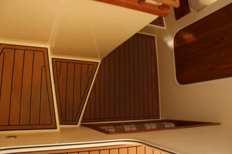 Slide: The Image of Interior view of 2016 Eastern 27' Islander boat with wood paneling and flooring. - 24