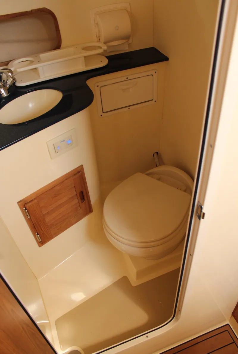 Slide: The Image of Compact bathroom in 2016 Eastern 27' Islander boat with sink and toilet. - 29