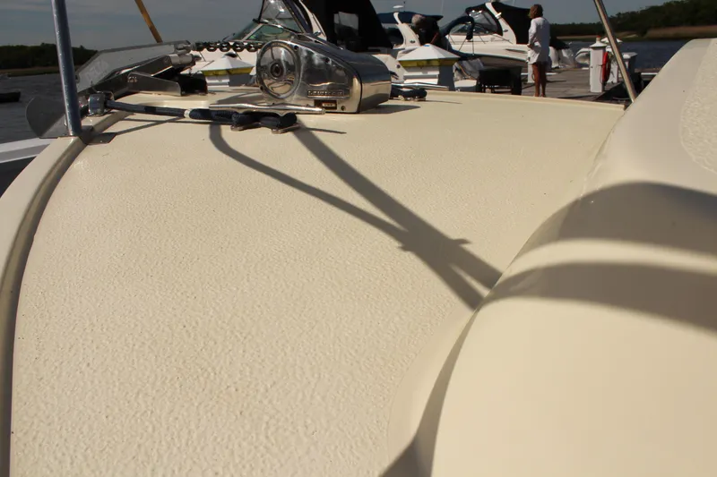Slide: The Image of 2016 Eastern 27' Islander boat deck with winch, docked alongside other boats. - 32