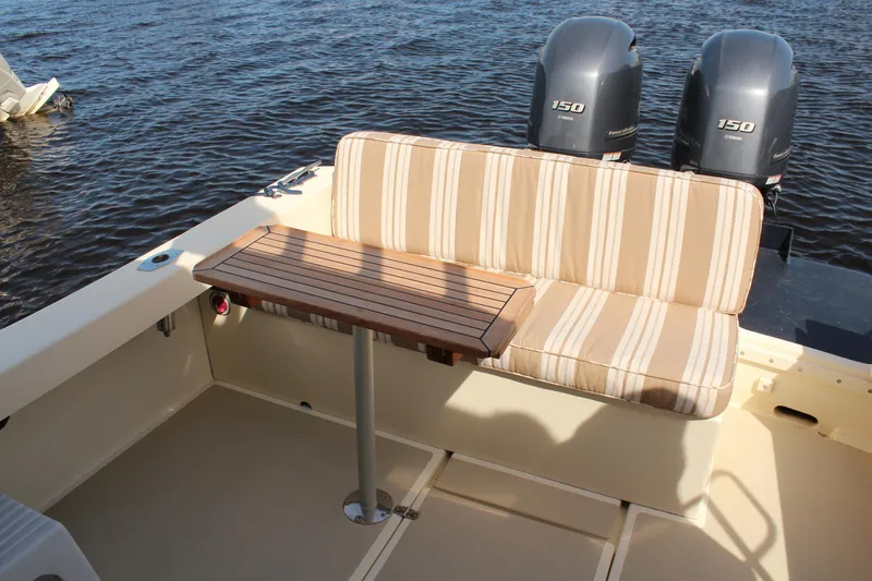 Slide: The Image of 2016 Eastern 27' Islander boat interior with striped seating and wooden table. - 35