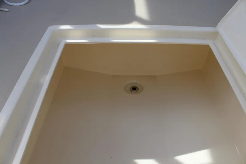 Slide: The Image of Storage compartment on 2016 Eastern 27' Islander boat, featuring a drain hole. - 38