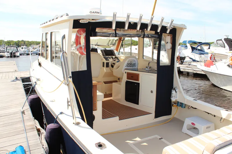 Slide: The Image of 2016 Eastern 27' Islander boat docked at marina, featuring spacious cockpit and modern interior. - 4