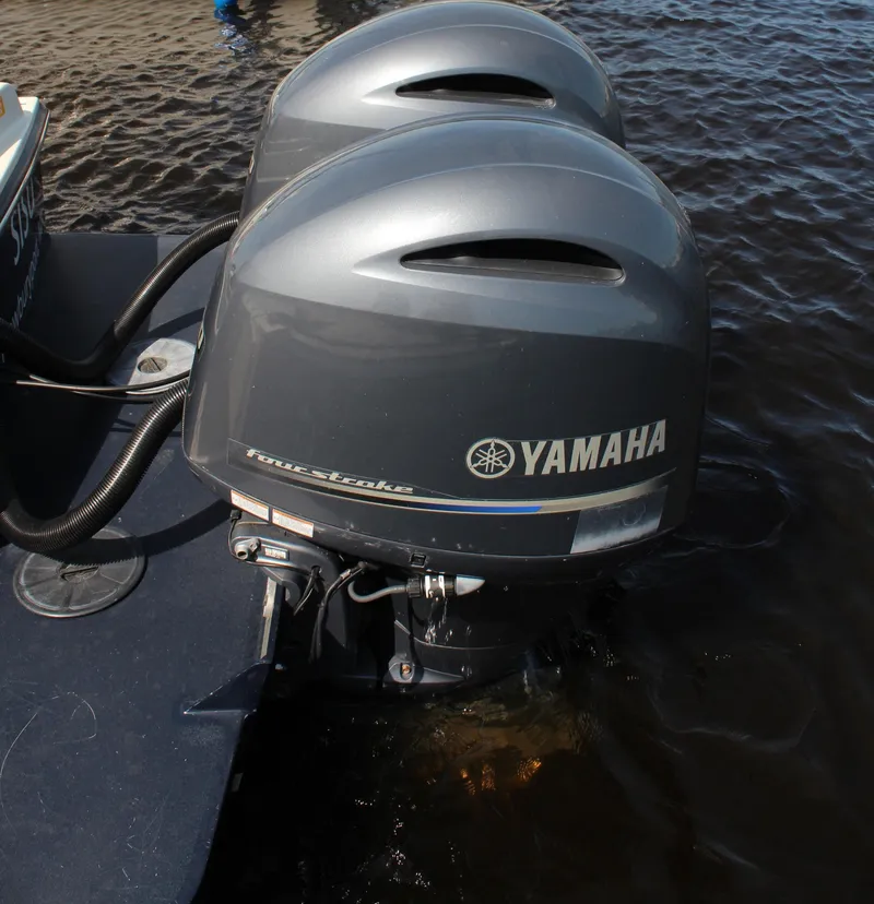 Slide: The Image of Twin Yamaha outboard motors on a 2016 Eastern 27' Islander boat in water. - 42