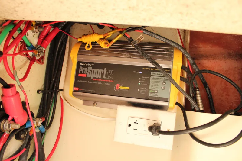 Slide: The Image of Battery charger setup in 2016 Eastern 27' Islander boat with wiring and outlet. - 43