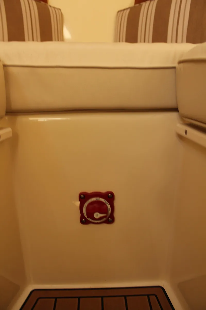 Slide: The Image of Interior of 2016 Eastern 27' Islander boat with striped cushions and control knob. - 49