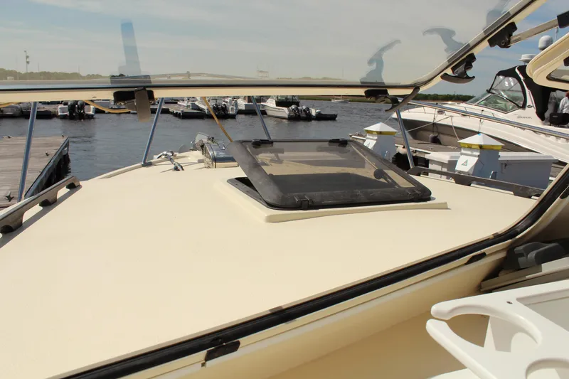 Slide: The Image of 2016 Eastern 27' Islander boat docked at marina, featuring open hatch and sleek design. - 6