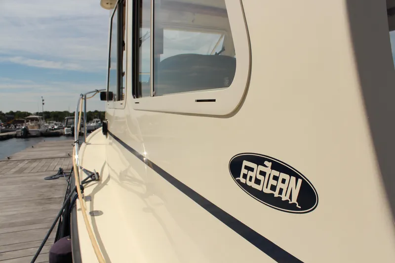 Slide: The Image of 2016 Eastern 27' Islander boat docked, showcasing sleek design and logo. - 7