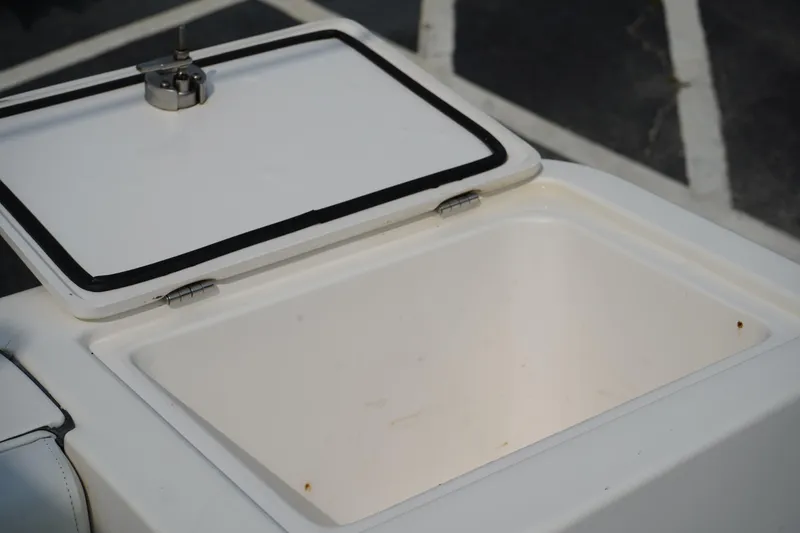 Slide: The Image of Open storage compartment on 2014 Edgewater 245CC boat, showing interior space. - 10