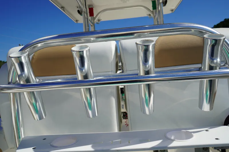 Slide: The Image of Stainless steel rod holders on a 2014 Edgewater 245CC boat under clear blue sky. - 14