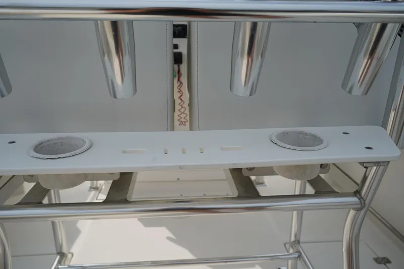 Slide: The Image of 2014 Edgewater 245CC boat interior with rod holders and speakers. - 15