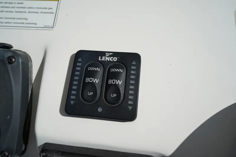 Slide: The Image of Lenco trim tab control panel on 2014 Edgewater 245CC boat dashboard. - 29
