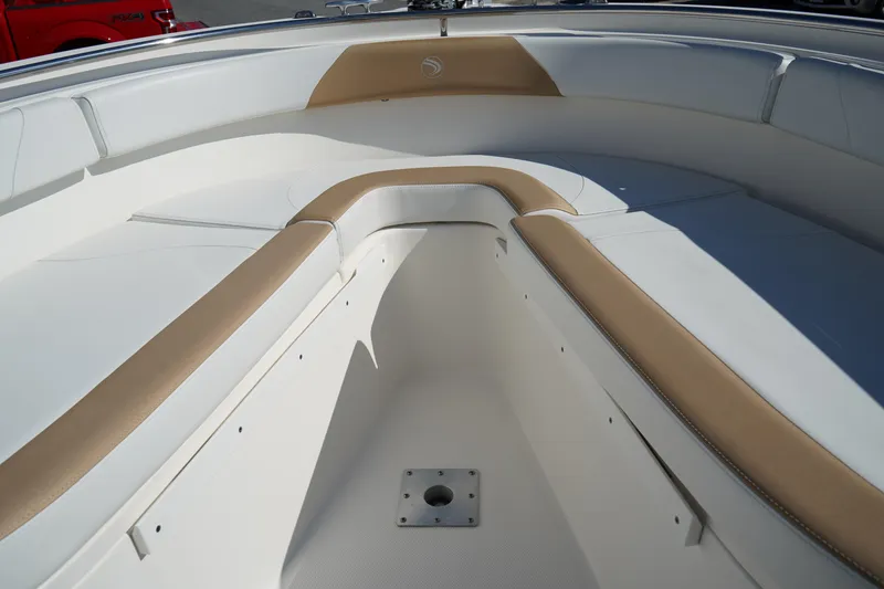 Slide: The Image of Interior view of 2014 Edgewater 245CC boat with tan and white seating. - 41