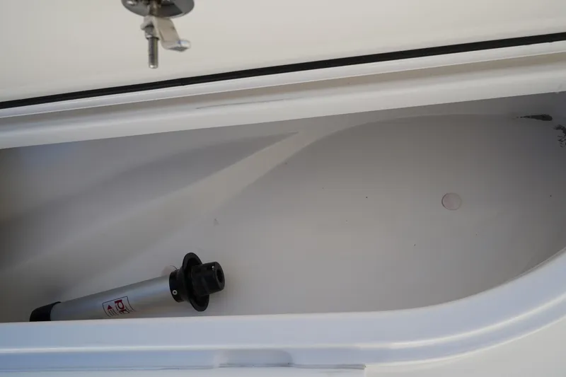 Slide: The Image of Storage compartment of 2014 Edgewater 245CC boat with a hydraulic support rod. - 43
