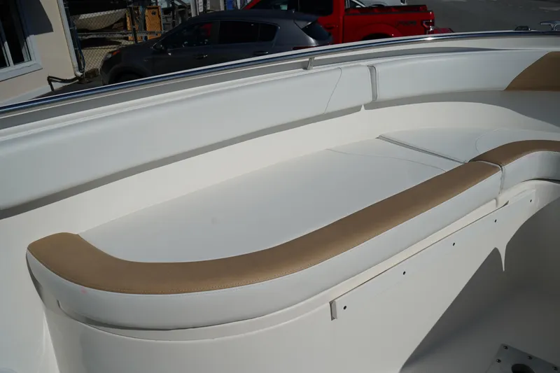 Slide: The Image of 2014 Edgewater 245CC boat interior with white and tan seating. - 45