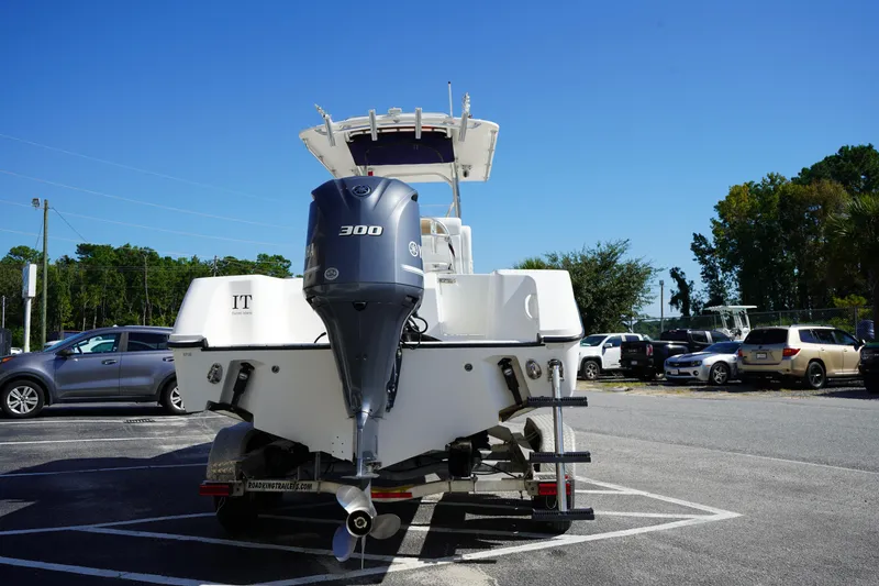 Slide: The Image of Edgewater 245CC 2014 boat with 300 HP engine on trailer in parking lot. - 6