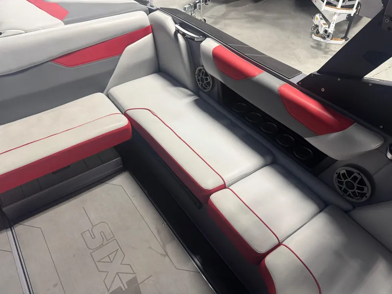 Slide: The Image of 2021 Axis A22 boat interior with gray and red seating, cup holders, and speakers. - 10