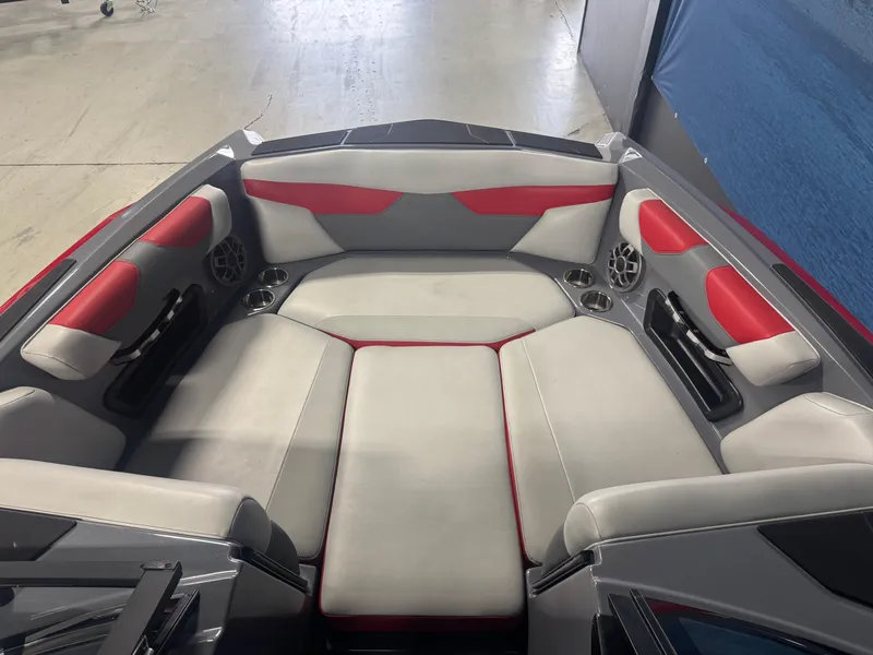 Slide: The Image of 2021 Axis A22 boat interior with red and gray seating, featuring built-in speakers. - 14