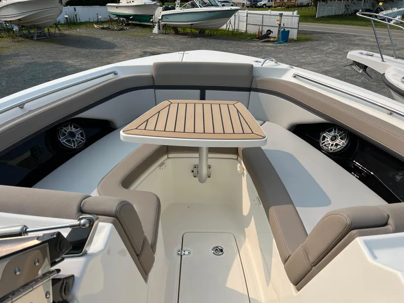 Slide: The Image of 2025 Boston Whaler 330 Vantage boat interior with seating and table. - 10