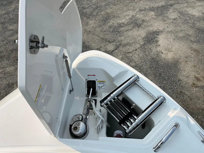 Slide: The Image of 2025 Boston Whaler 330 Vantage anchor compartment with ladder and storage. - 11