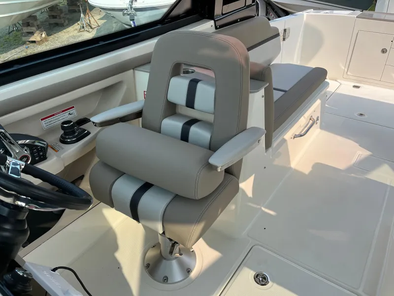 Slide: The Image of 2025 Boston Whaler 330 Vantage interior with modern seating and controls. - 17