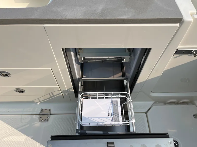 Slide: The Image of 2025 Boston Whaler 330 Vantage boat storage compartment with open drawer. - 22